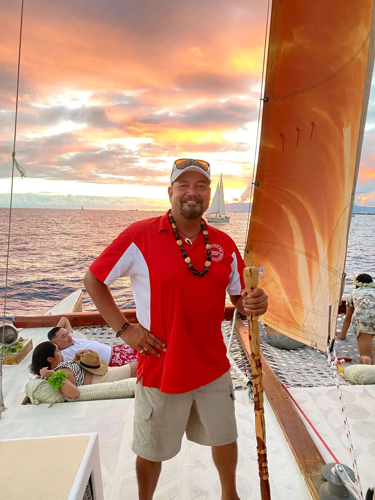 Traditional sailing canoe with a Native Hawaiian crew on a cultural sunset sail off Waikiki near Honolulu